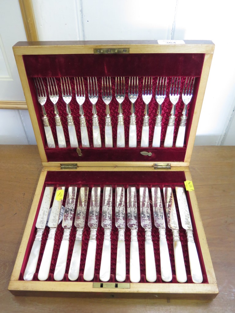 A canteen of tea knives and forks with mother of pearl handles for twelve