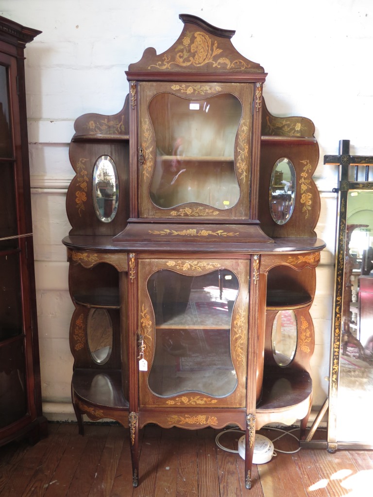 A late 19th century French inlaid mahogany display cabinet, the shaped pediment over a glazed