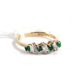 A seven stone emerald and cubic zirconia 9 carat gold ring