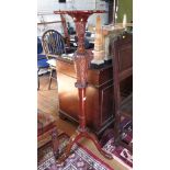 A George III style mahogany torchere stand, the pie-crust edge top over an acanthus carved