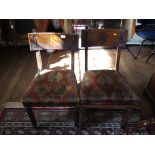 Two Victorian stained wood dining chairs, in the Gothic style, each with broad top rail