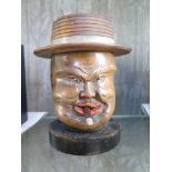 A carved softwood Chinaman tobacco jar