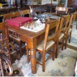 A stained pine dining table and eight chairs by Dixy, the table with frieze drawer 180cm x 100cm,