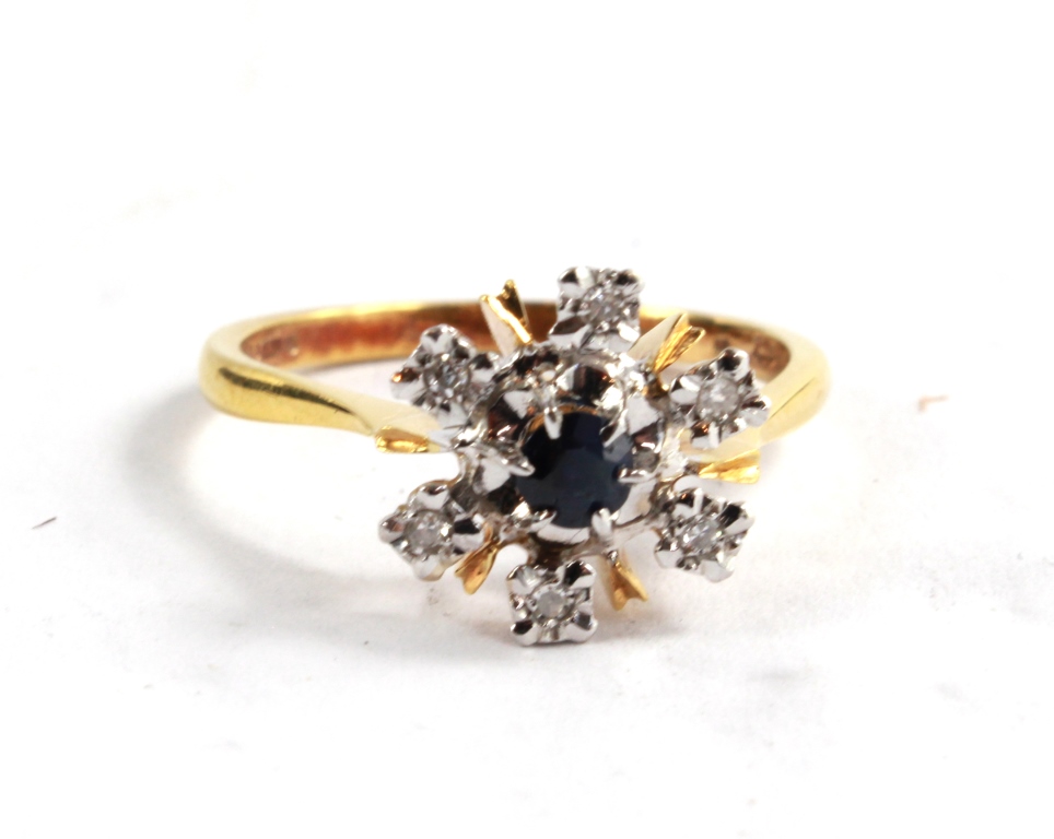 An 18 carat gold, diamond and sapphire cluster ring
