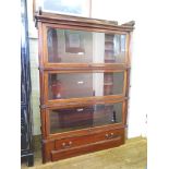 A Globe Wernicke mahogany stacking bookcase, the raised back over three glazed serpentine tiers over