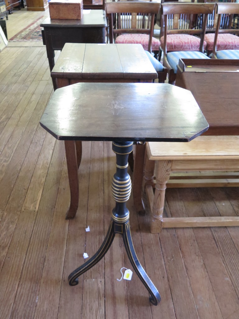 A Regency ebonised and gilded adjustable wine table, the associated mahogany top on a turned