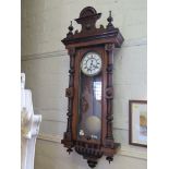 A Viennese type wall clock, with turned pendants and half turned supports enclosing an enamelled