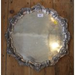 A large round silver tray with gadrooned edges on three ball and claw feet, 58 troy oz, 44.5cm