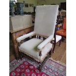 A 17th century style walnut barley-twist arm chair, with high upholstered back, stuff-over seat