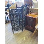 An Edwardian walnut purdonium with carved panel, an Indian three-fold fire screen and a folding cake