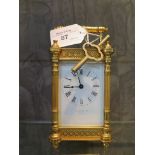 A gilded cased carriage timepiece with white enameled dial, Roman numerals, made in France, single