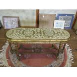 A 19th century French giltwood long stool, the upholstered seat over a moulded ribbon carved