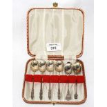 A case of silver coffee spoons, five and one