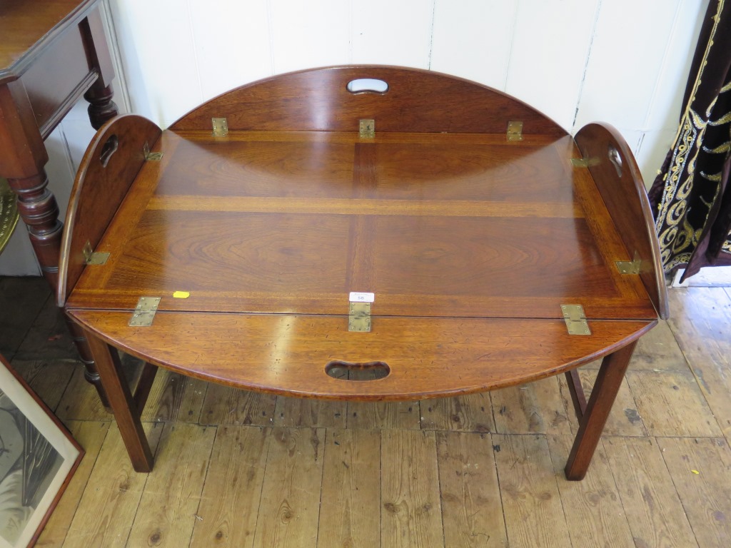 A 19th century style mahogany Butlers tray, of oval form with hinged sides, on a stand 121cm x