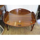 A 19th century style mahogany Butlers tray, of oval form with hinged sides, on a stand 121cm x
