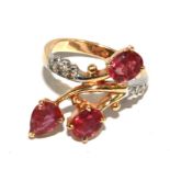 A ruby and diamond ring set in gold colour metal