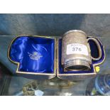 A Victorian silver mug gilded to the interior, with bright cut decoration, in original