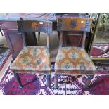 Two Victorian stained wood dining chairs, in the Gothic style, each with broad top rail