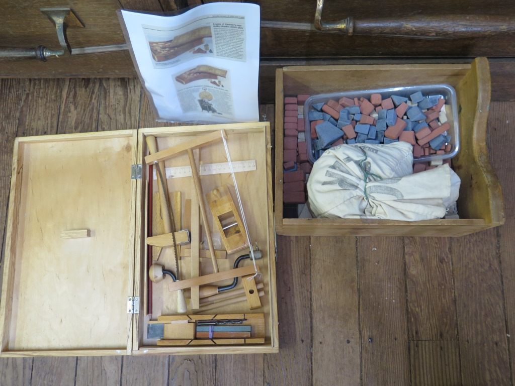 Various coloured child's building blocks, 1900s, a collection of marbles, and a toy carpentry set