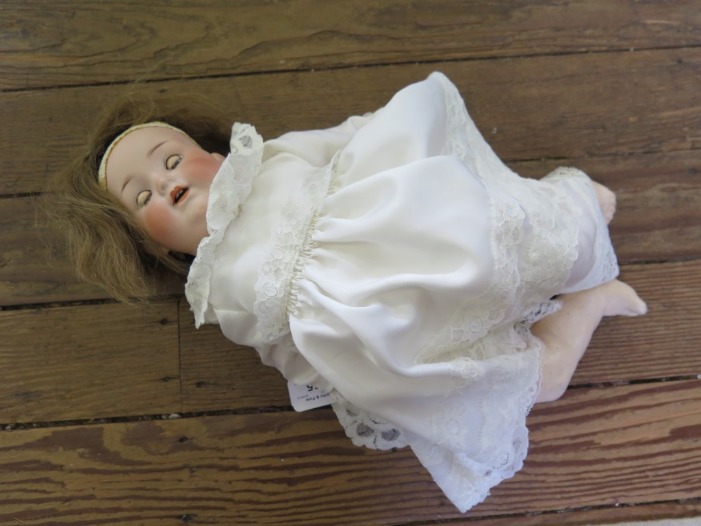 An Armand Marseille doll, 990/3 with closing brown eyes, open mouth and teeth, composite body 41cm