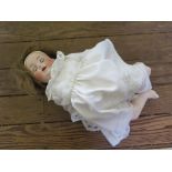 An Armand Marseille doll, 990/3 with closing brown eyes, open mouth and teeth, composite body 41cm