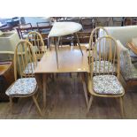 An Ercol elm drop leaf dining table, with black and gold label 75cm wide, four hoop back dining