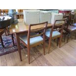 A Fyne Ladye Afromosia extending dining table and four ladderback chairs, the table with one extra