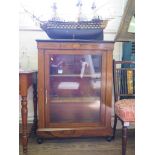 A Victorian inlaid rosewood display cabinet, the patera inlaid frieze over a glazed door on ebonised