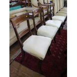 A set of four Regency mahogany dining chairs, with panelled top and mid rails, above overstuff seats