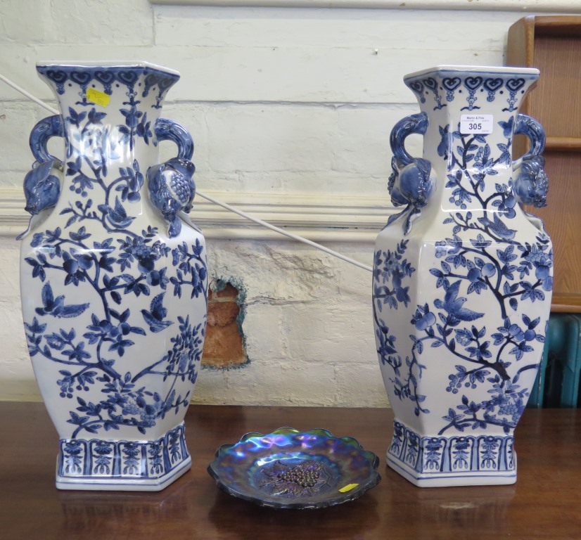 A pair of Chinese style blue and white vases, depicting birds in fruiting vines, with pomegranate