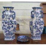 A pair of Chinese style blue and white vases, depicting birds in fruiting vines, with pomegranate