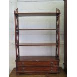 A George III style mahogany hanging bookcase, the four shelves with feet carved supports over two