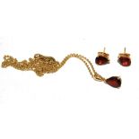A garnet pendant set on 18 carat gold neck chain together with matching garnet earrings