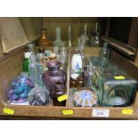 A collection of glass bottles, a ship in a bottle and paperweights