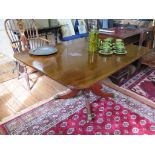 An early 19th century mahogany snaptop breakfast table, the rectangular top on a turned column