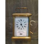 A brass carriage time piece with enamel dial, and single train movement 14cm high