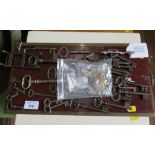 A collection of antique keys, including a folding key, anti-burglar key with spring action and