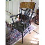 An Edwardian ebonised turned armchair, in the American style, the inlaid mahogany top rail inset