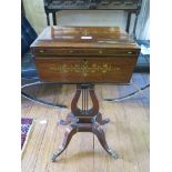 A Regency rosewood and brass inlaid teapoy, with ring handles, the hinged lid enclosing four caddies