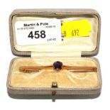 A 15 carat gold bar brooch set with central amethyst in fitted box