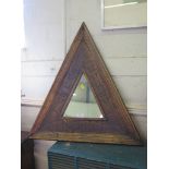 A triangular ethnic design mirror, 66 x 63cm
