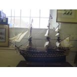 A scale model of H.M.S. Victory, in full sail with guns at the ready 101cm long, 76cm high