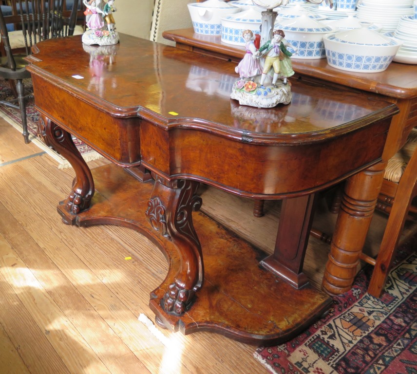 A mid Victorian burr walnut console table, the shaped top with frieze drawer on cabriole supports