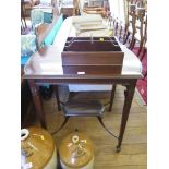 An Edwardian mahogany window table, the shaped top over a fluted frieze on rosette and flute