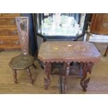 A Welsh oak spinning chair, carved with dragons, and dated 1896, and an Indian carved hardwood table