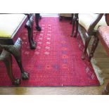 A Bokhara style carpet, the rows of small guls on a red field within a multiple geometric border,
