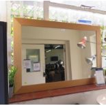 A light oak framed rectangular wall mirror, 75cm x 106cm