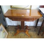 A Regency mahogany foldover tea table, the panelled frieze with scroll brackets over a reeded
