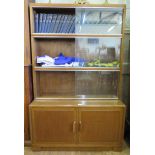 An oak Minty stacking bookcase, the three tiers of shelves with sliding glass doors above a pair