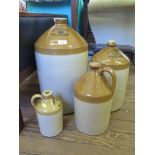 Three stoneware flagons for Wheelers, Wycombe, largest 51cm high and another flagon (4)